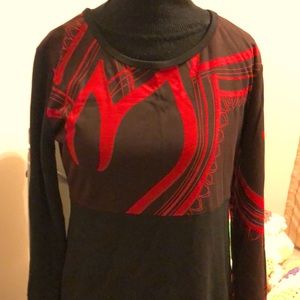Long sleeve fitted shift style dress. Black black with red geometric design.